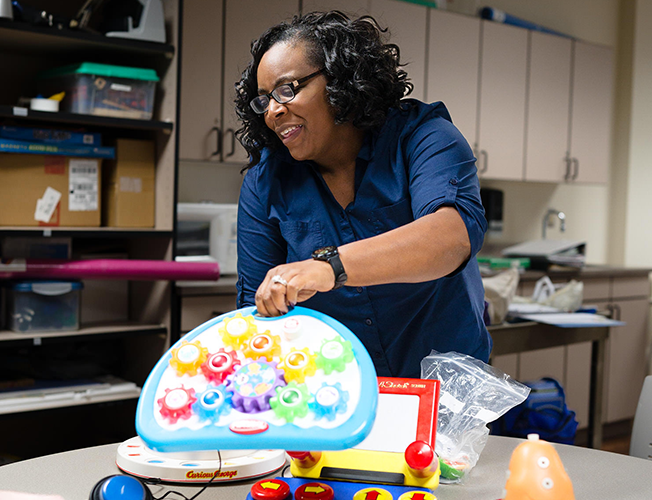 Early childhood instructor demonstrates children's toys