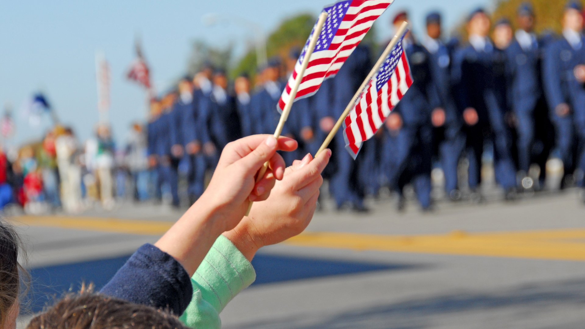 Handheld American Flags at Parade.